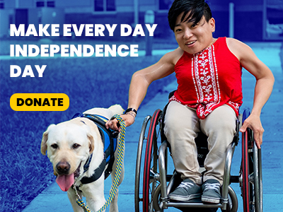 Image of a woman in a wheelchair being pulled by her yellow lab service dog in pull harness with the text Make Every Day Independence Day with a donate button