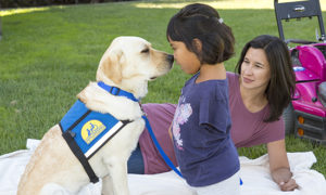 child and adult with Canine Companions service dog