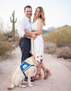 two people standing with Canine Companions service dog