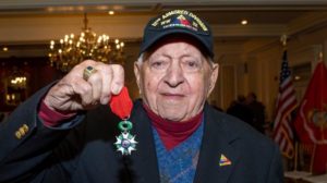 Military veteran holding a medal