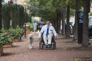 person in wheelchair with Canine Companions service dog