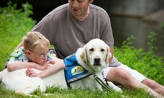 adult and child with Canine Companions service dog