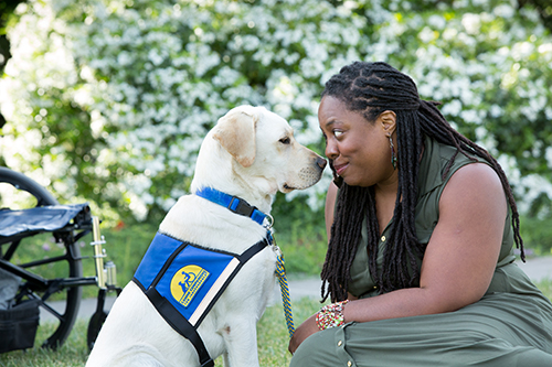 person nose to nose with Canine Companions service dog
