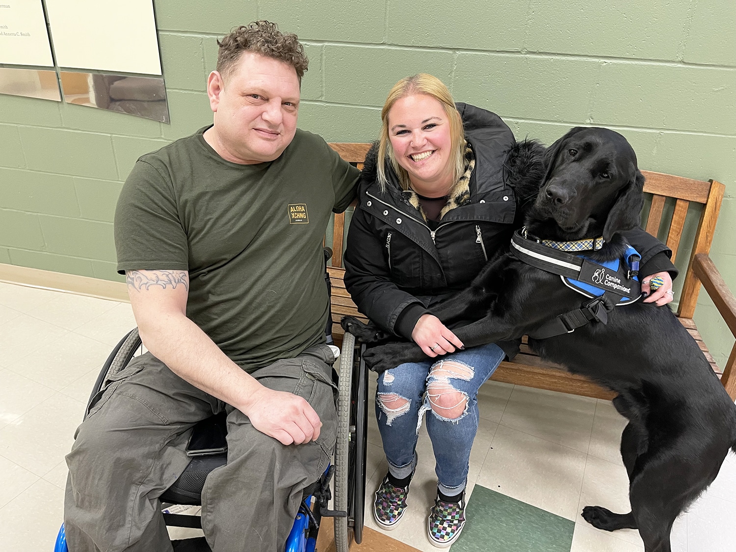 Man and woman sitting together with service dog