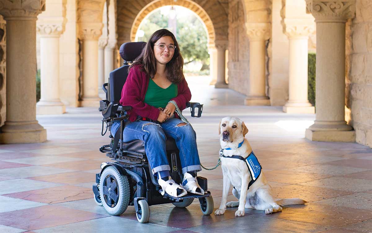 Young woman with her service dog at Stanford