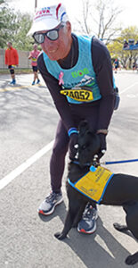 Runner greets future service dog at Boston Marathon