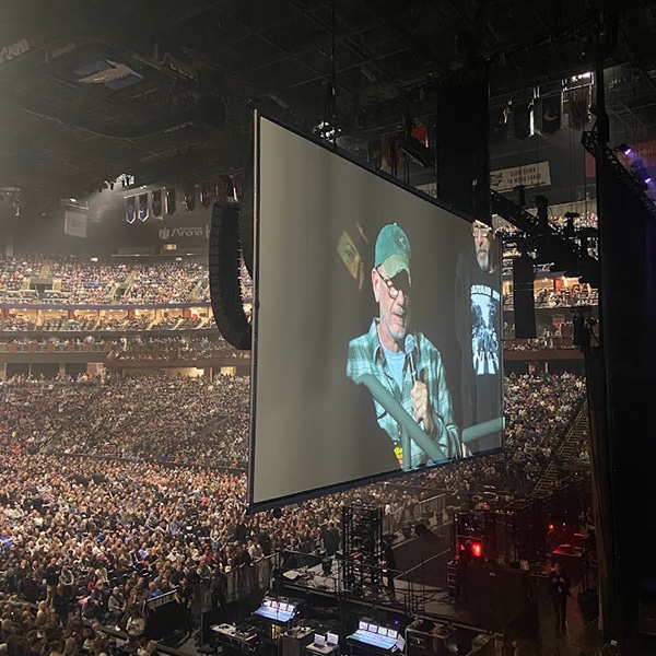 Veteran Jay is projected on a large screen as he speaks to a packed arena.