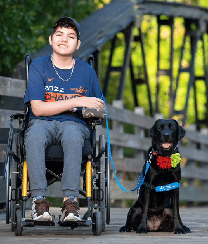 Boy in wheel chair with his service dog
