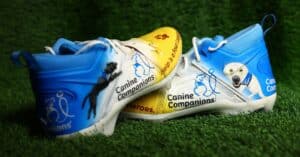 Yellow and blue Canine Companions-themed cleats on display ahead of the Chiefs vs. Bengals game.