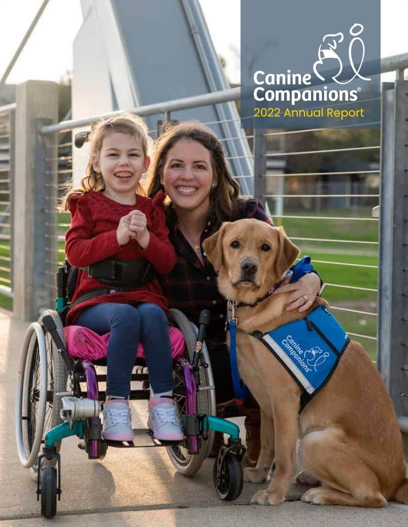 Cover of the 2022 Annual Report featuring a young girl in a wheelchair next to her mom and yellow lab service dog in a blue service vest
