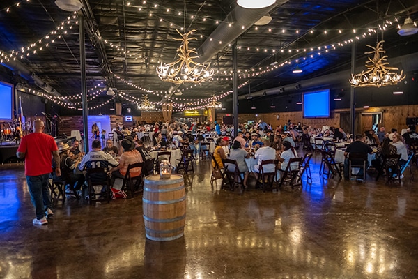 Inside photo of river ranch venue with tables and people