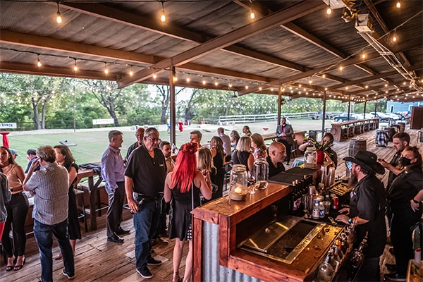 Outside photo of river ranch venue with tables and people