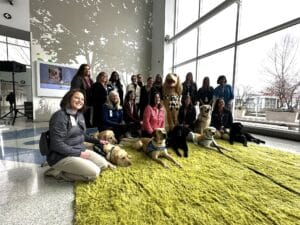 Canine Companions and Nationwide Children's Hospital staff gather with a group of facility and therapy dogs at the new Canine Corner.
