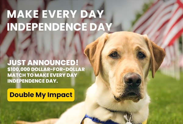 A yellow Labrador Retriever sits in front of a field of American flags. The text reads 'MAKE EVERY DAY INDEPENDENCE DAY. JUST ANNOUNCED! $100,000 Dollar-for-Dollar Match to Make Every Day Independence Day.' A button below says 'Double My Impact'.