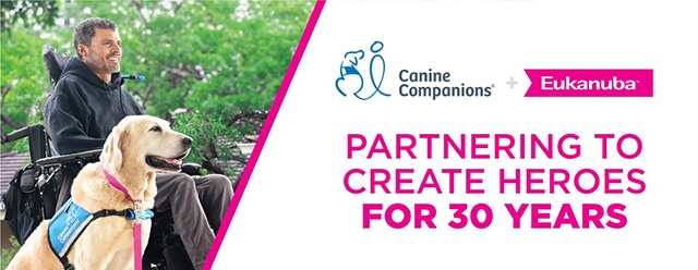 A man in a wheelchair with a service dog, alongside text that reads, "Canine Companions + Eukanuba, Partnering to Create Heroes for 30 Years."