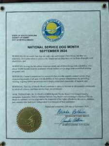 City of Myrtle Beach document declaring September 2024 as National Service Dog Month, signed by the mayor and city clerk.