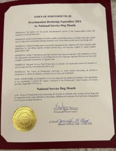 Proclamation Declaring September 2024 As National Service Dog Month by the Town of Portsmouth, RI, with a gold seal and signatures at the bottom.