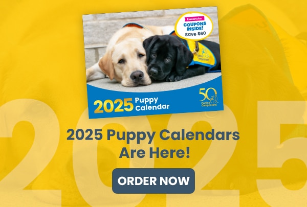 2025 Puppy Calendar advertisement with an image of two puppies and text promoting coupons and ordering.