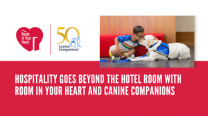 A child interacting with a service dog on a floor in a hotel lobby, with logos and text promoting the "Room In Your Heart" initiative and "Canine Companions."