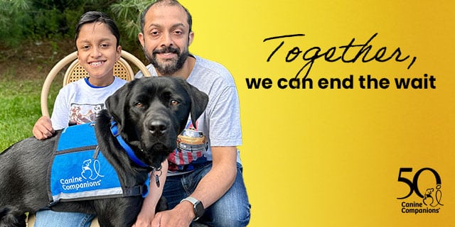 A boy and a man sit together outdoors with a service dog wearing a blue vest that reads 'Canine Companions.' The background is lush green, and there is a text overlay stating, 'Together, we can end the wait.'