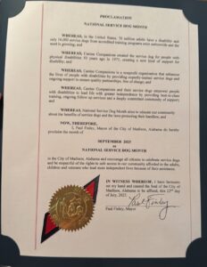 A proclamation document declaring September 2025 as National Service Dog Month, highlighting the importance of service dogs and the nonprofit organization Canine Companions, featuring an official seal and signature from Paul Finley, the Mayor of Madison, Alabama.