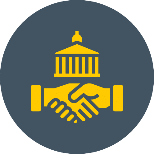 A graphic design featuring two hands shaking in yellow, symbolizing agreement or collaboration, with a government building silhouette above them, all set against a circular dark gray background.