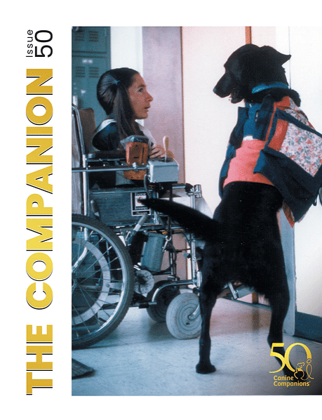 The cover of The Companion publication number 50 featuring a woman in a wheelchair interacting with a black dog wearing a colorful vest.