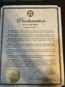 A proclamation document titled 'Proclamation Service Dog Month' for September 2023, featuring a formal layout, signatures, and a city seal at the bottom left corner, highlighting the importance and contributions of service dogs.