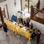 Canine Companions staff greet attendees at a registration table in a bright lobby