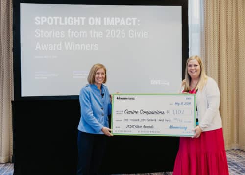 Two women pose with an oversized check for Canine Companions at the 2026 Give Awards presentation