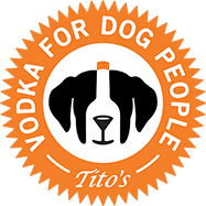 Tito's Vodka for Dog People logo with a black-and-white dog face in a circle on an orange background
